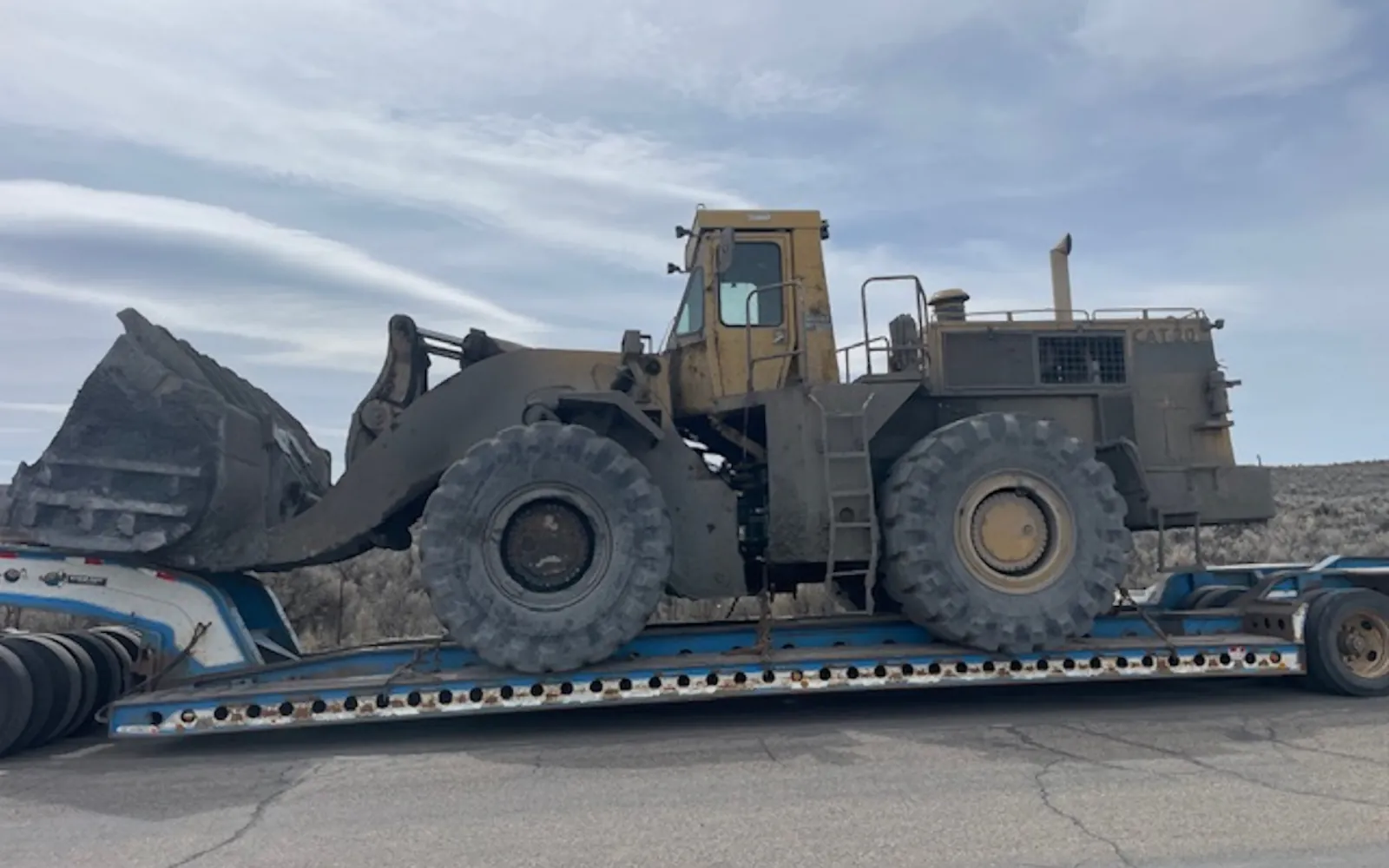 Loader secured on a lowboy trailer
