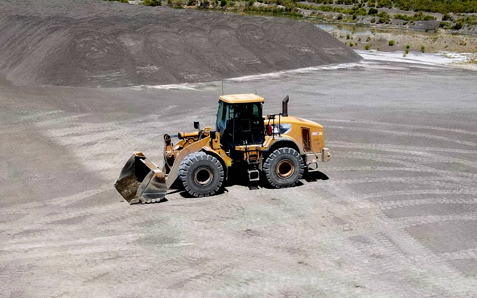 Loader waiting for incoming dump truck