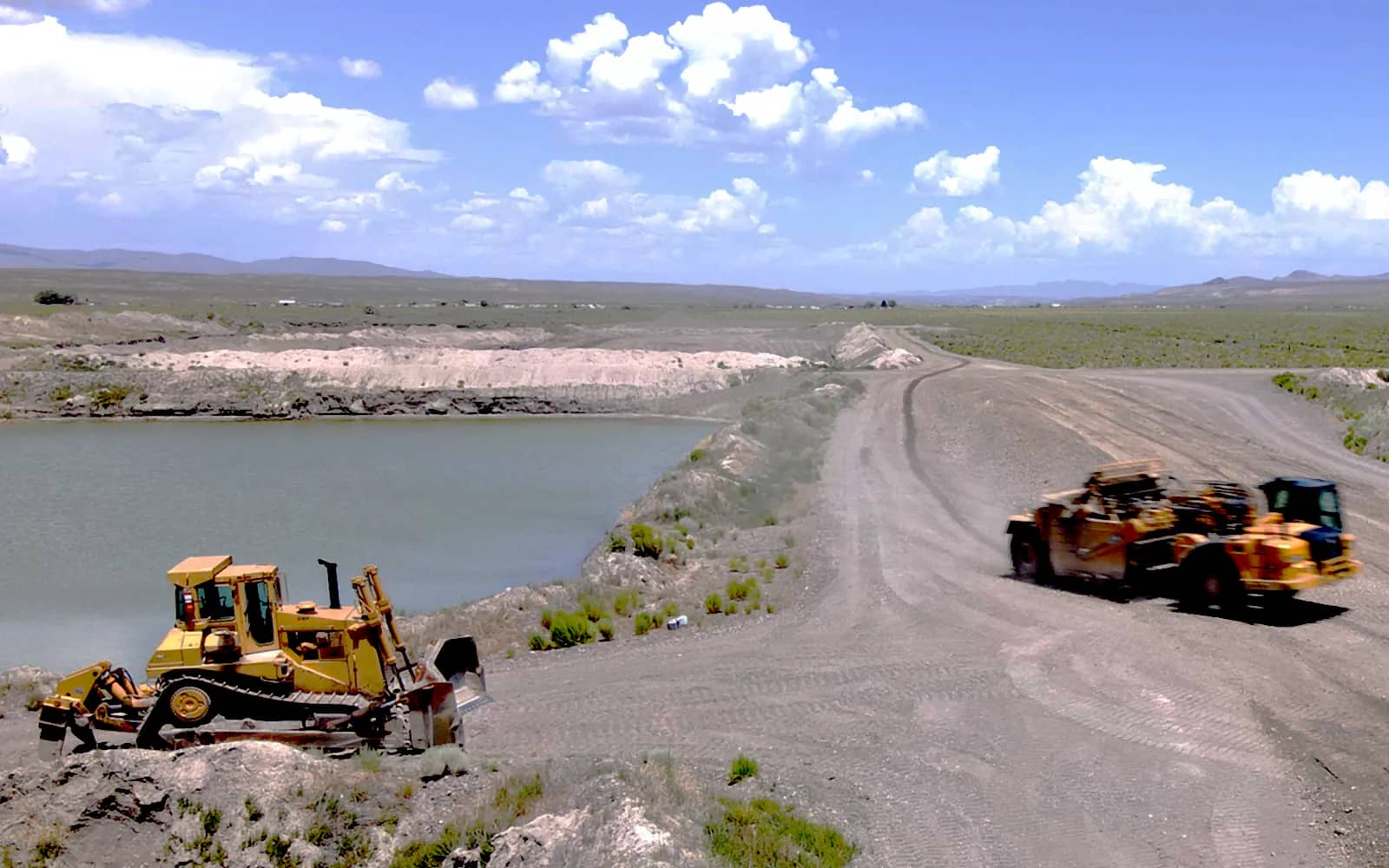 Scraper ready to unload with dozer standing by